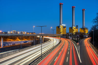 Highway and  power station at night seen in berlin, germany