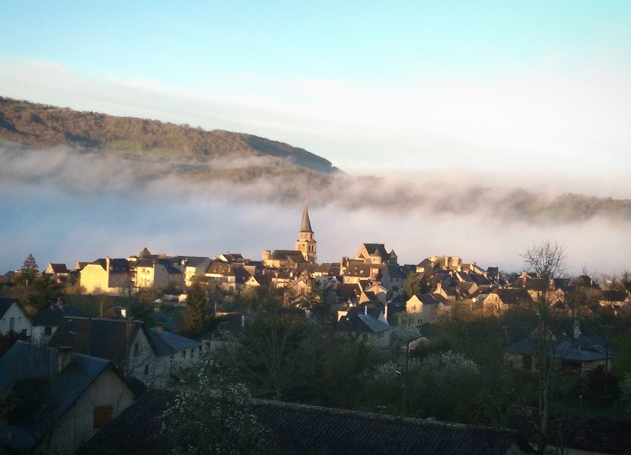 building exterior, architecture, built structure, residential district, sky, house, residential structure, high angle view, cityscape, residential building, mountain, city, crowded, town, townscape, landscape, tree, fog, cloud - sky, community