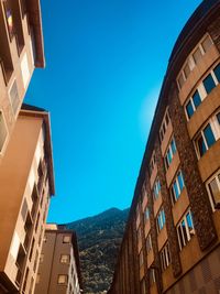 Low angle view of buildings against blue sky