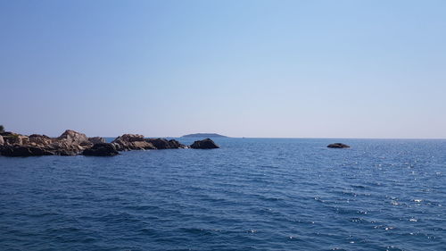 Scenic view of sea against clear blue sky