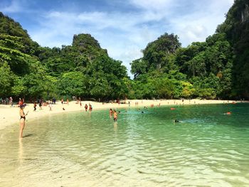 Group of people swimming in sea