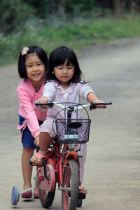 Portrait of a smiling girl riding bicycle