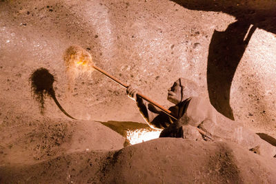 High angle view of fire on sand