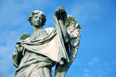 Low angle view of statue against sky