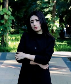 Portrait of a beautiful young woman standing outdoors