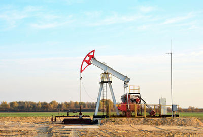 Traditional windmill on field against sky