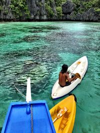 High angle view of woman sitting in sea