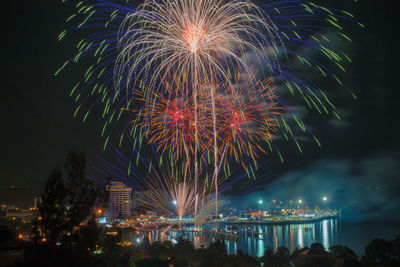 Low angle view of firework display at night