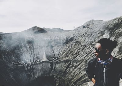 Man standing on mountain against sky