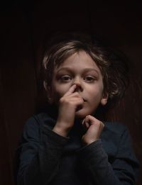 Portrait of boy picking nose