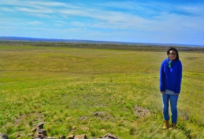 Full length of young woman standing in field