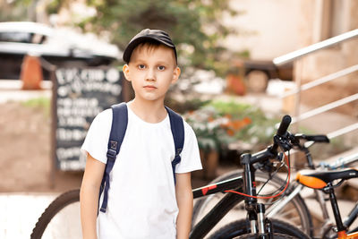 Portrait of boy standing on bicycle