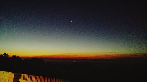 Scenic view of silhouette landscape against sky at night