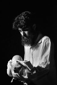 Portrait of a young man against black background