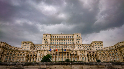 Low angle view of building against cloudy sky