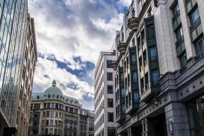 Low angle view of buildings against cloudy sky