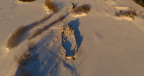 Aerial view of abandoned ship in snow covered land