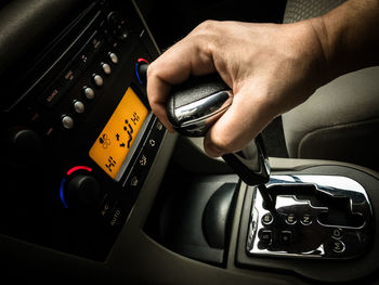 Close-up of man holding gearshift