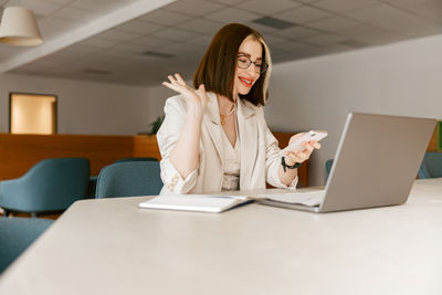 Young woman using laptop at office