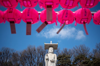 Low angle view of illuminated lanterns against sky