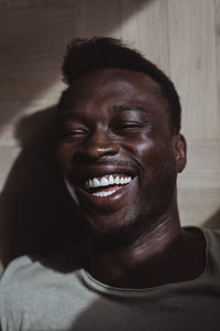 Close-up of smiling man at home
