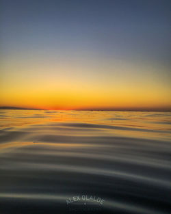 Scenic view of sea against clear sky during sunset