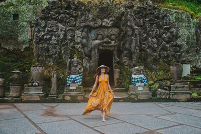 Full length of woman walking at goa gajah