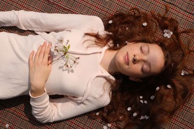 Portrait of woman lying down on bed