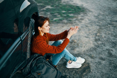 High angle view of woman sitting outdoors