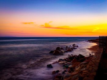 Scenic view of beach against sky during sunset