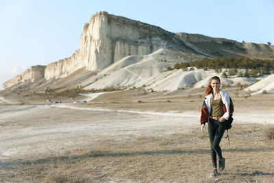 Rear view of woman walking on road