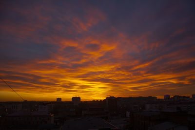 Silhouette buildings against sky during sunset