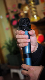 Male singer holding a wireless microphone during public performance