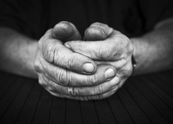 Cropped image of man with hands clasped