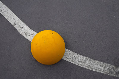 High angle view of yellow spherical bollard on street