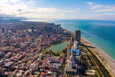 High angle view of buildings by sea against sky