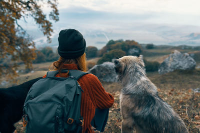 Rear view of woman with dog during winter