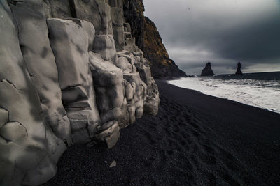 Scenic view of beach against sky during winter