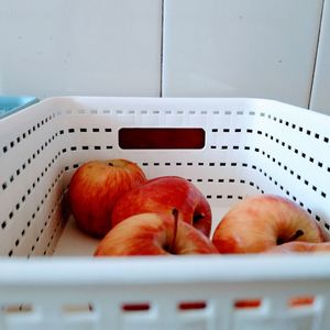 Close-up of apples in basket on table