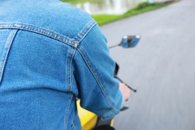 High angle view of man riding motorcycle on road