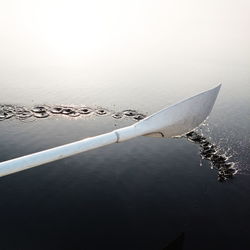 Close-up of oar on lake