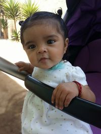 Close-up of innocent baby girl in stroller