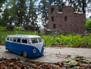 Toy car in park by building