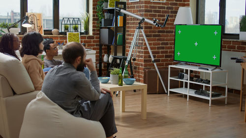 Colleagues watching tv at office