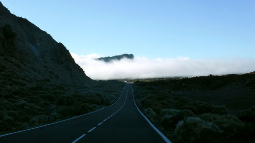 Panoramic view of road leading towards mountains against sky