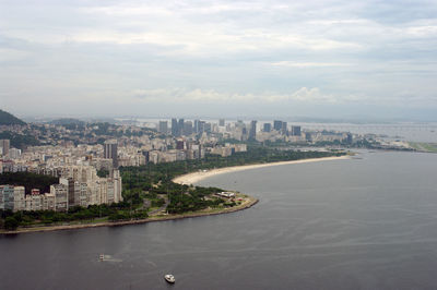 Buildings by sea against sky in city