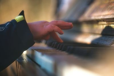 Midsection of person playing piano