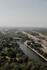 High angle view of river amidst city against sky