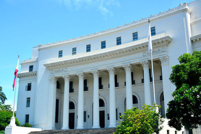 Low angle view of historic building against blue sky