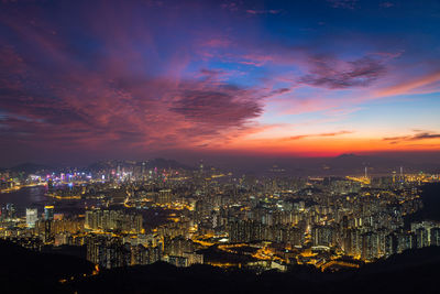 High angle view of illuminated buildings against sky at night